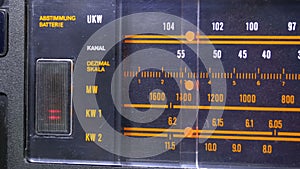 Tuning analog radio dial frequency on scale of the vintage receiver