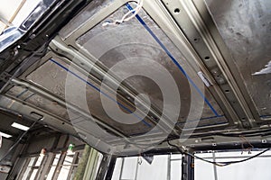 Tuning the car in a van bus body with three layers of noise insulation on the metal roof. Sound and vibration isolation using soft