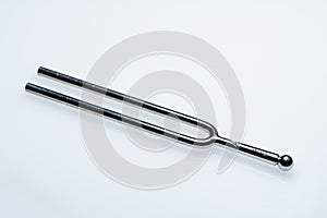 A tuning fork 440 Hz on a white background