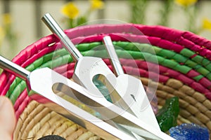 Tuning fork and crystal stone on a table .