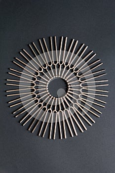 Tuning fork round pattern on a black background, centered circular pattern