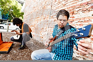 Tuning his guitar