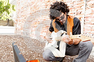 Tuning his guitar