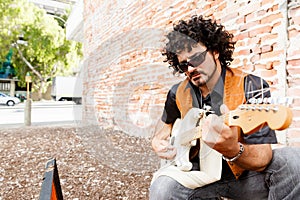 Tuning his guitar