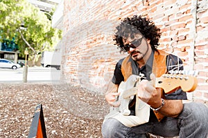 Tuning his guitar