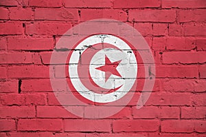 Tunisia flag is painted onto an old brick wall