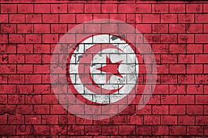 Tunisia flag is painted onto an old brick wall