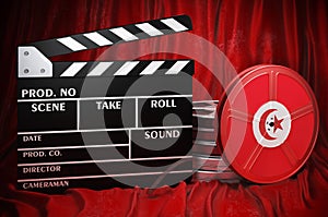 Tunisian cinematography, film industry, cinema in Tunisia. Clapperboard with and film reels on the red fabric, 3D rendering