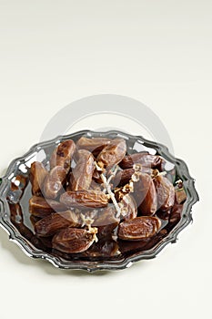 Tunisian Dates or Kurma Tunisia isolated on Cream Background for Breaking the Fast or Buka Puasa