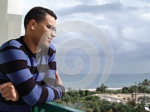 Tunisian man watching the ocean photo