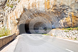 Tunnel carved in stone on mountain ridge near Omis view