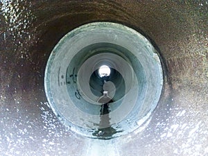 Tunnel for draining rainwater under the road. View through the pipe