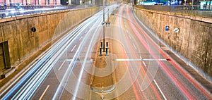 Tunnel entrance car light trails at night