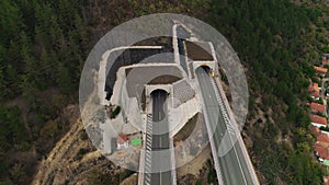 Tunnel entrance drone shot superstructure Road entering a hill