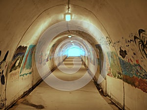 Tunnel going under California freeway, leading to the beach and ocean.