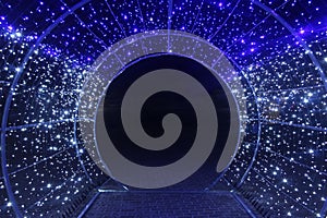 Tunnel and illuminations of blue white on a black dark background. New Year`s Eve Christmas. Photoona festive atmosphere