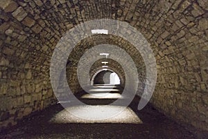 Tunnel of old castle with the light at the end