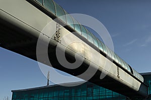 Tunnel over road outside. Pipe for pedestrians. Infrastructure at transport hub. Details of way around city