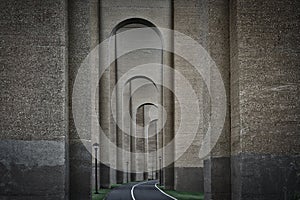 Tunnel or a passage with a series of tall arches and bike lane in NYC