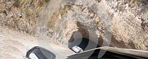 Tunnel and road curving through red rock sandstone. in himachal pradesh india .