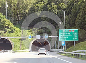 tunnel and road signs on the motorway with directions to locations in Switzerland photo