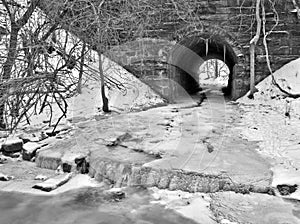 Tunnel with snow and ice filled stream
