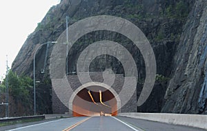 Tunnel through Solid Rock with Lights and a Car Inside