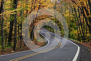 Tunnel of trees in autumn time along scenic byway M41 in Keweenaw peninsula in Michigan upper peninsula photo