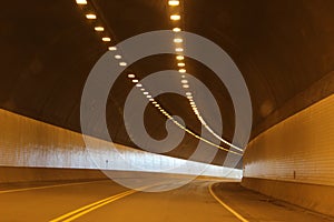 Tunnel Turns a Corner with Two Rows of Lights in the Ceiling