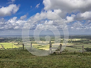 Tunning vibrant landscape image of English countryside on lovely Summer afternoon overlooking rolling hills and country villages