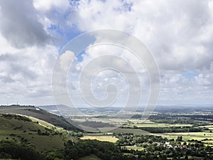 Tunning vibrant landscape image of English countryside on lovely Summer afternoon overlooking rolling hills and country villages