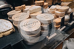 Tunworth Cheese Co cheese on sale at Neal`s Yard Dairy stall inside Borough Market, London, UK