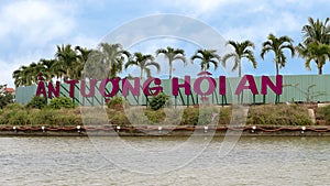 An Tuong Hoi An sign with plam trees in background, Thu Bon River, Hoi An