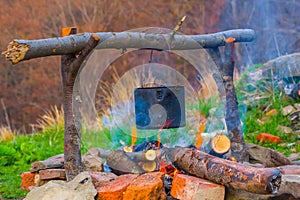 Tuoristic cauldron on a camp fire photo