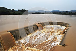 Turbid water in the dam overflows into the spillway