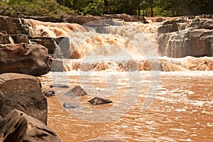 Turbid water of tropical waterfall after hard rain