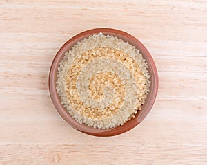 Turbinado sugar in bowl on a wood table top