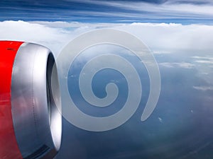 The turbine of the airplane above the clouds close up