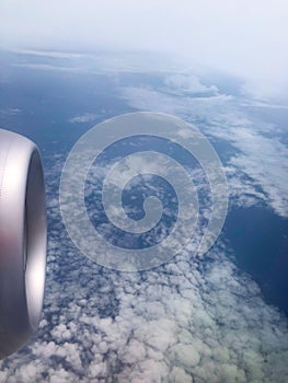 The turbine of the airplane above the clouds close up