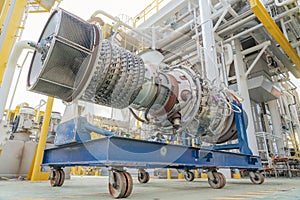 Turbine engine of gas compressor on offshore oil and gas central processing platform removed from enclosure to maintenance.