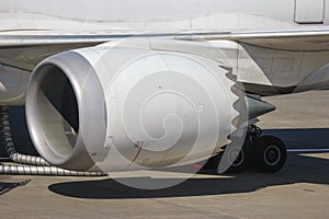 Turbine engine part of airplane with airport runway as background