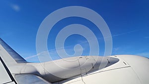 Turbine of a flying airplane on a background of blue sky, close-up - view from the illuminator - 17s