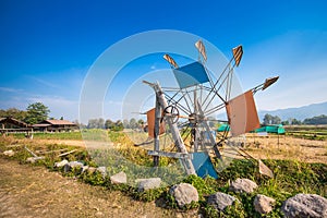 Turbine in the rice fields in the countryside with blue sky and clouds