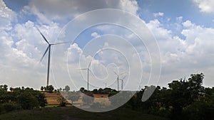 A turbines  of solar panels with wind rotating on mountains