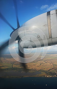 Turbo Prop Engine in Flight over Ocean and Island Coastline