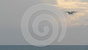 Turboprop aircraft flying over the sea