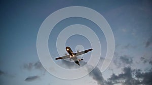 Turboprop aircraft flying slow motion over head at sunset or sunrise