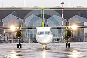 Turboprop airplane aircraft with the included engines on taxi at the airport.