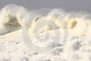 Turbulent ocean wave with sea spray tossed up