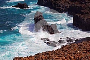 Turbulent ocean waves crashing into rocky shoreline of Sao Nicolau island, Cape Verde photo